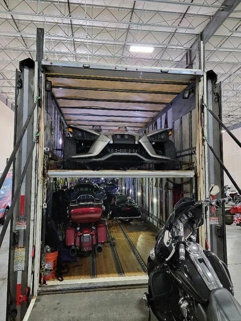 "Car Shipping Florida - enclosed trailer loaded with motorcycles and vehicles"