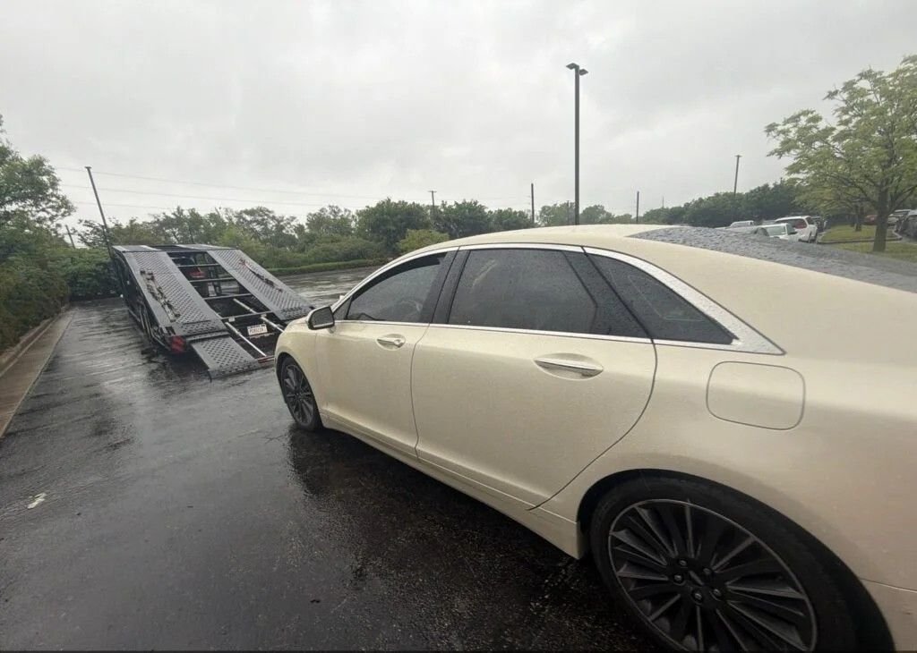 Tailored car shipping service with vehicle loading onto a transport trailer